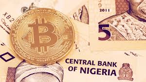 Naira notes and a Bitcoin coin